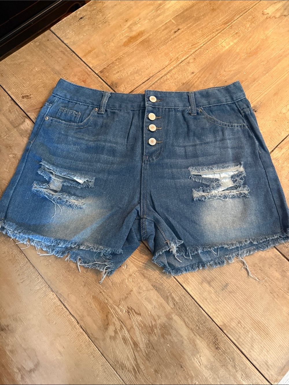 High-Rise Distressed Denim Shorts in Blue